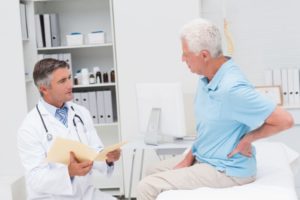 male doctor discussing with older patient