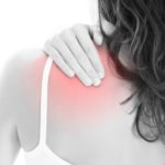 woman touching her aching shoulder