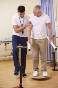 physiotherapist with older patient