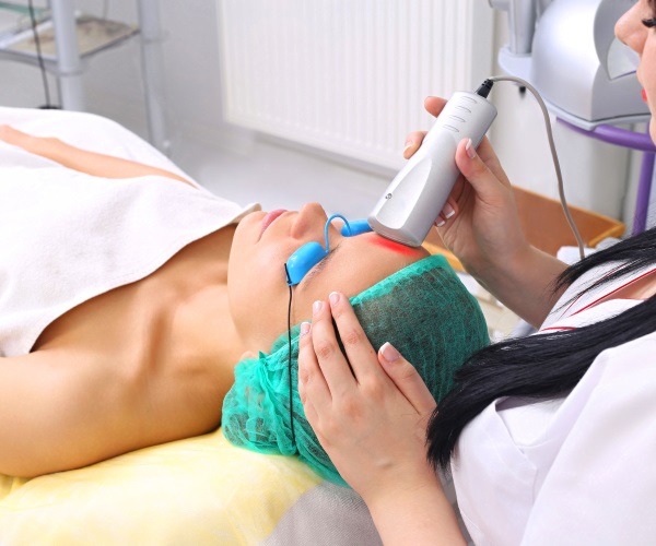young woman receiving cold laser therapy