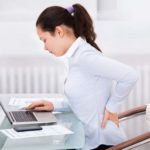 woman at the computer having back pain