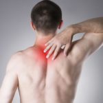 a man with upper back pain