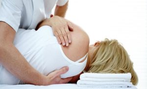 a woman receiving chiropractic treatment