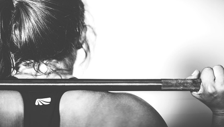 woman from the back holding weights