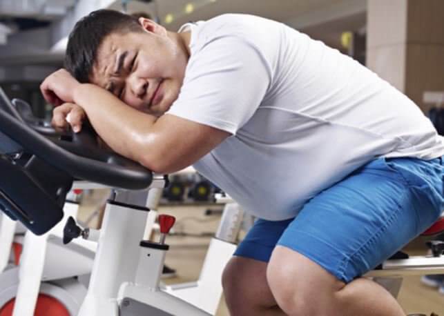 unhappy fat guy in the gym