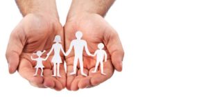chiropractor hands holding little paper people