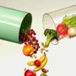 fruit and vegetables coming out of a large pill