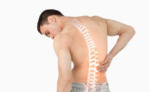 man with visible spine holds his back