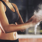 woman crossfitter putting chalk on her hands