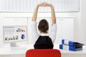 woman stretching at the office desk