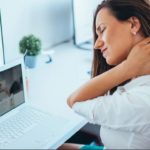 woman sitting at the computer with neck pain