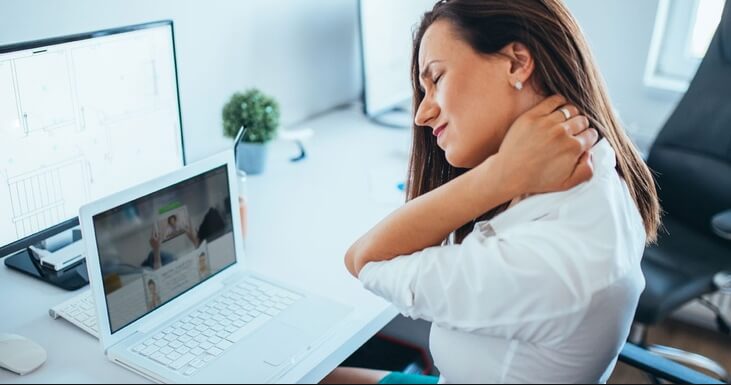 woman sitting at the computer with neck pain