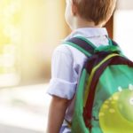 a boy with school backpack