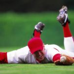 baseball player on the ground catching ball