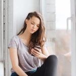 young woman texting on smartphone