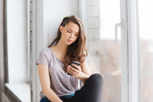 young woman texting on smartphone