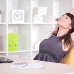 woman stretching in her office chair