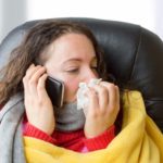 sick woman holding her phone