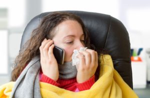 sick woman holding her phone