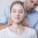 woman having her neck adjusted by a chiropractor