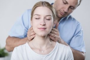 woman having her neck adjusted by a chiropractor