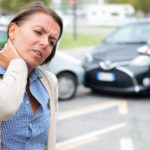 woman in car accident having whiplash