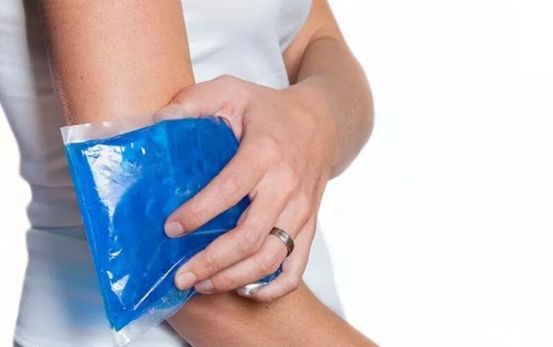 woman holding ice pack on her arm