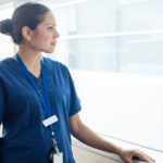 nurse looking through a window